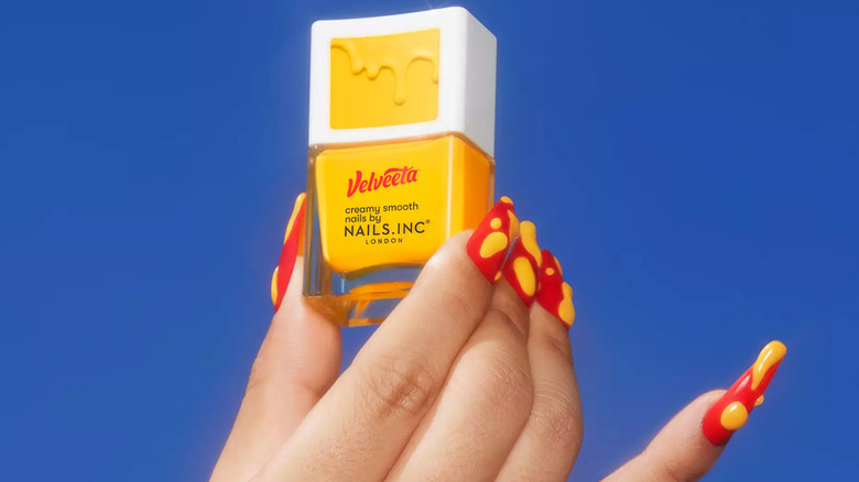 Person's hand holding Velveeta nail polish