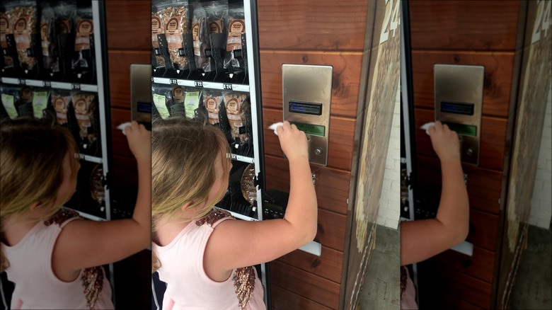 Girl using pie vending machine