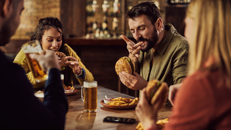 People eating burgers in pub