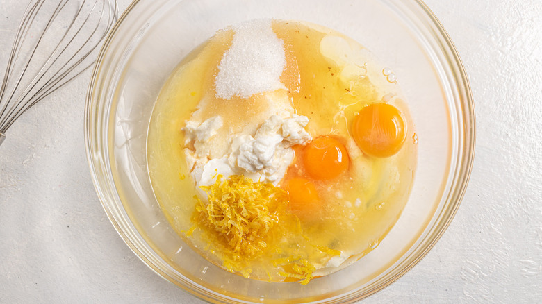 Bowl with yogurt, ricotta cheese, eggs, sugar, vanilla, lemon zest, and lemon juice