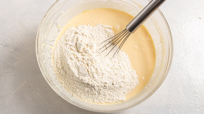 Bowl with pancake batter and flour