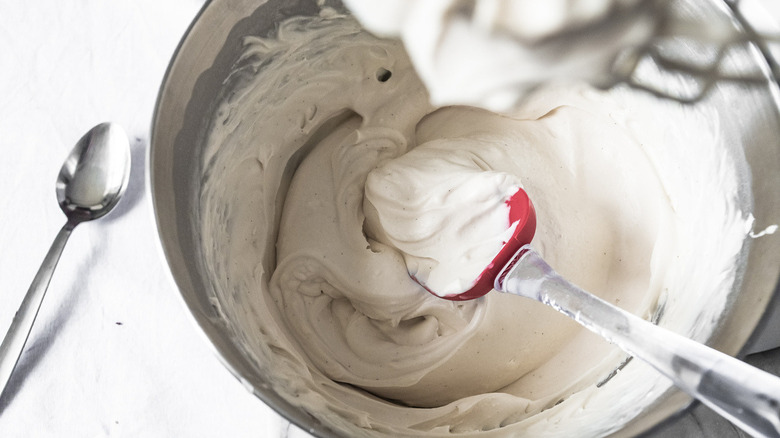 whipping cream mixture in a metal mixing bowl