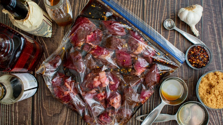 seasoned steak marinating in sealed bag