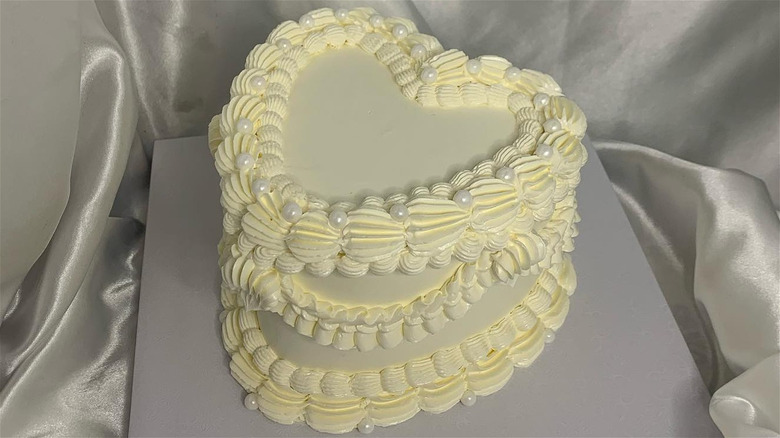 Heart shaped cake decorated with piping and pearls