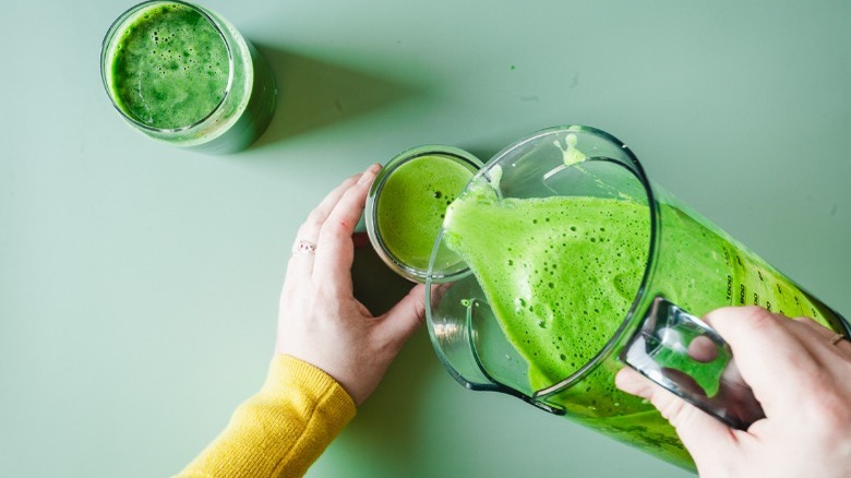 pouring green juice from pitcher