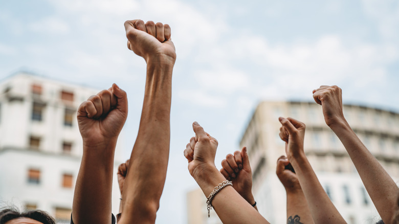 Strikers, fists raised