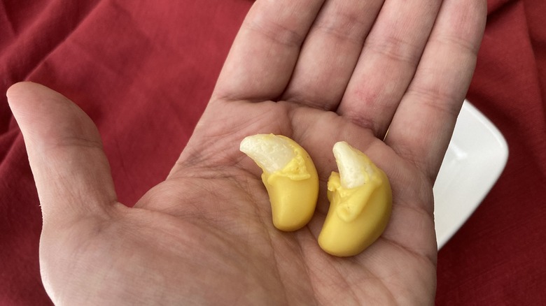 hand holding peeled banana gummies