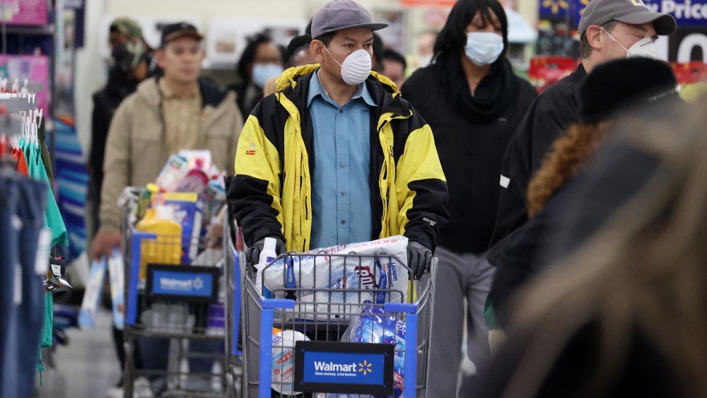 Line of shoppers wearing face masks in Walmart