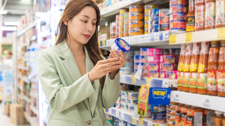 Woman looking at tuna in the store