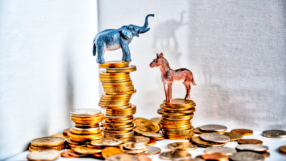 Donkey and elephant on top of stacked coins