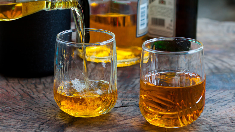 whiskey pouring into glasses