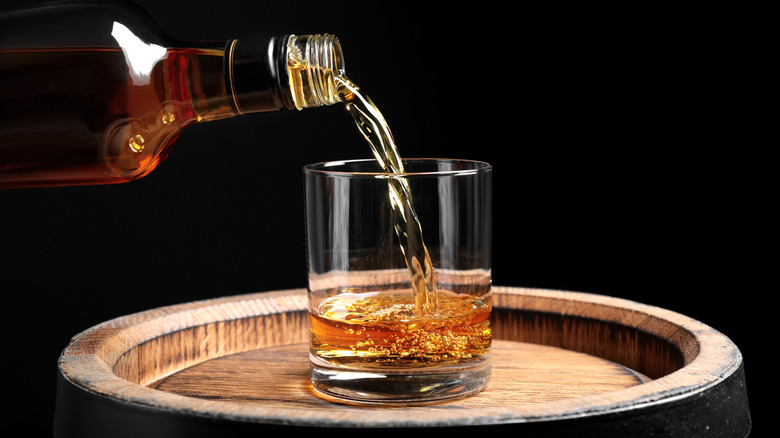 whiskey being poured into glass