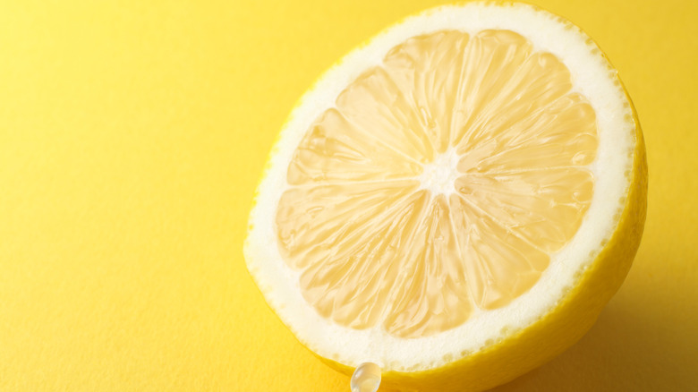 lemon half on yellow background