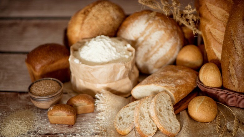 Various types of bread on a wooden table