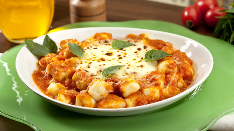 tomato gnocchi with melted cheese and basil