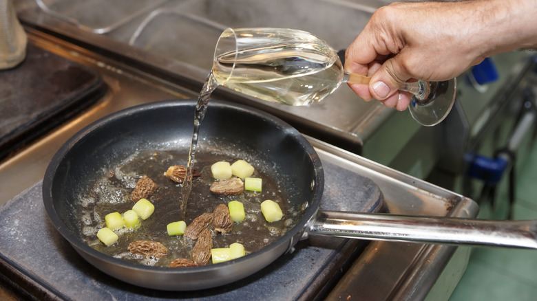 pouring wine into sauce