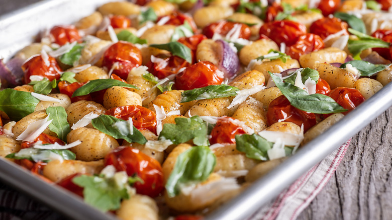 gnocchi, tomatoes, and basil on sheet pan