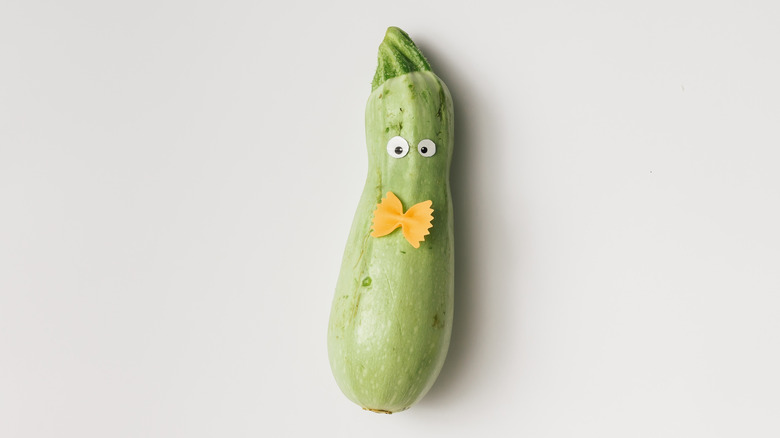 Zucchini with googly eyes and a pasta bowtie
