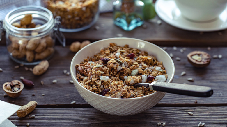 A bowl of granola on a wood table