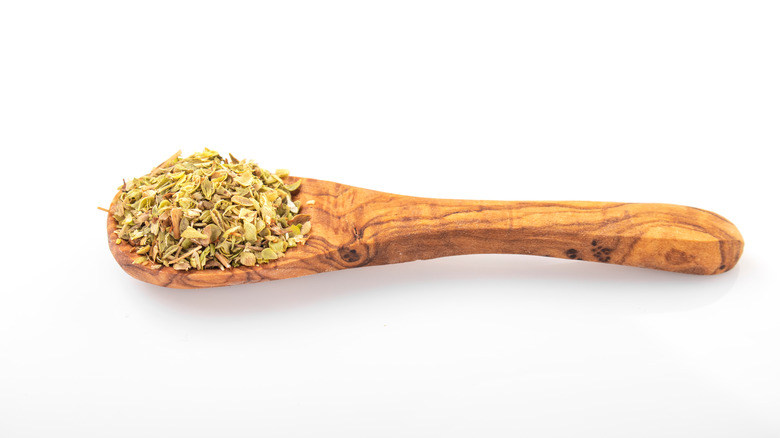 wooden spoon with dried oregano