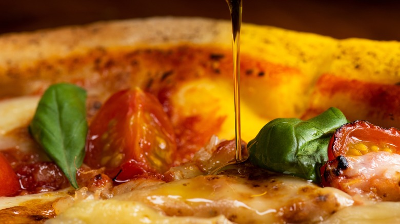 olive oil drizzled on pizza