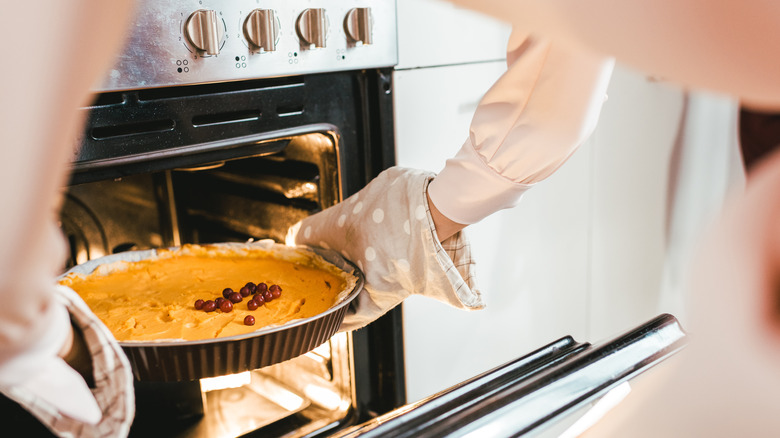 Taking pie out of oven