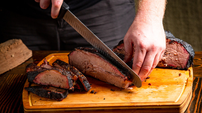 someone chopping brisket