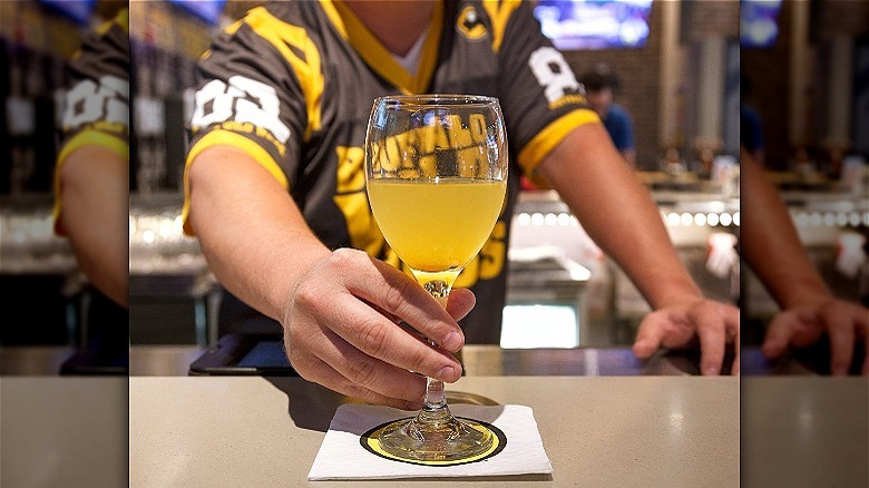 bartender serving alcoholic drink