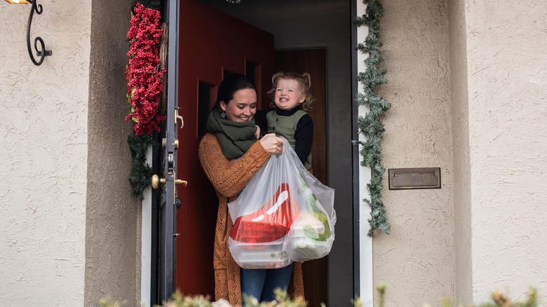 woman holding Chili's delivery bag