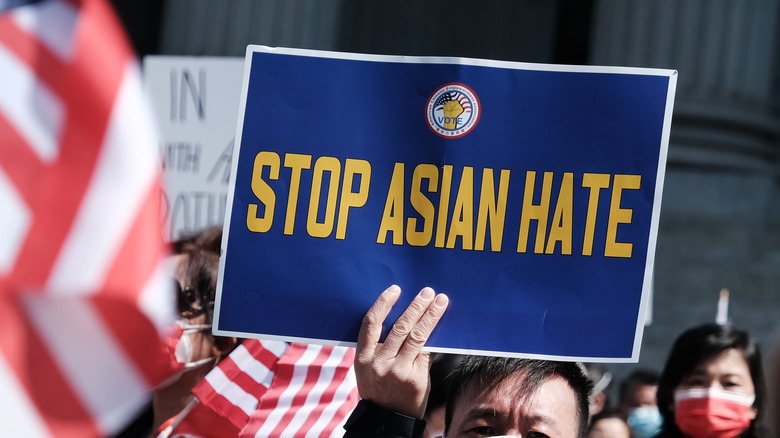 Man holding anti-racism sign