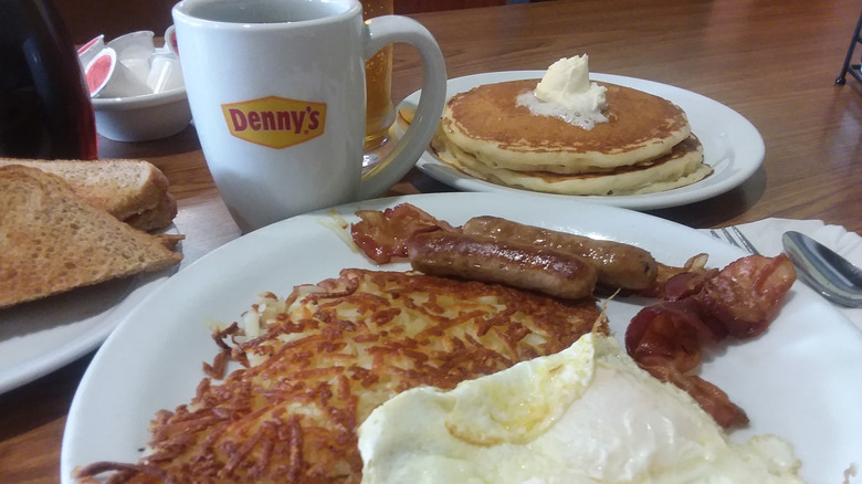 A plate of hash browns, eggs, and meats at Denny's