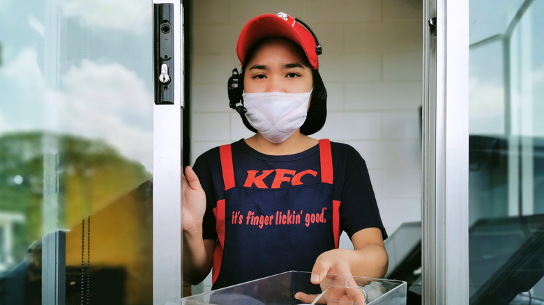 KFC employee at a drive-thru window