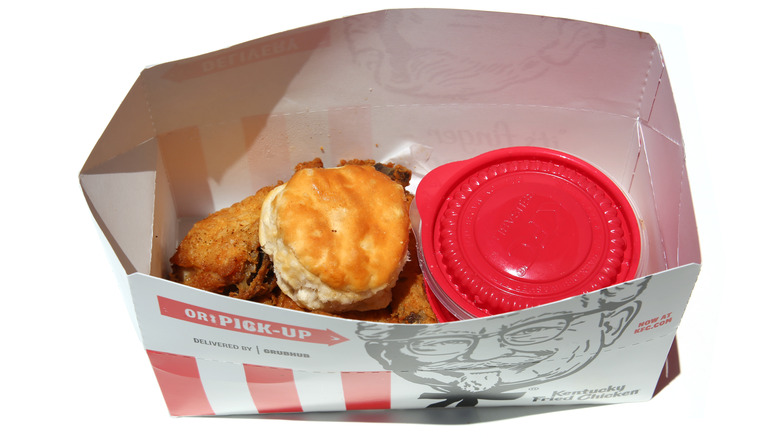 KFC biscuit and fried chicken in takeout box