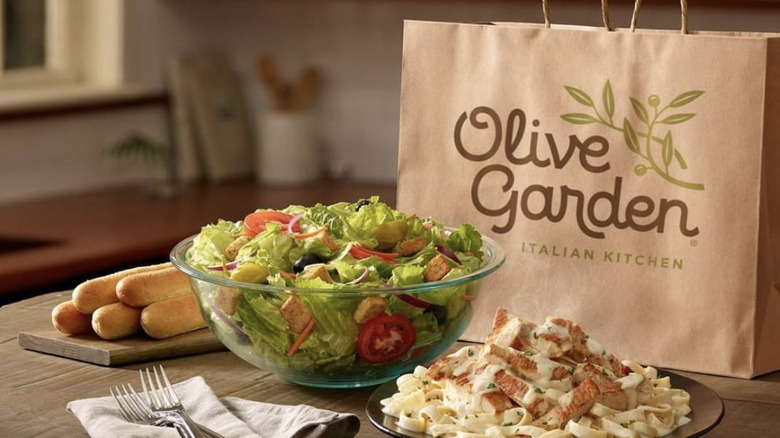 Olive garden take out bag, salad, breasticks, pasta