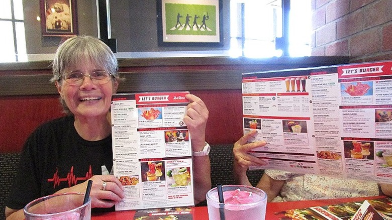 woman holding menu red robin cheap 