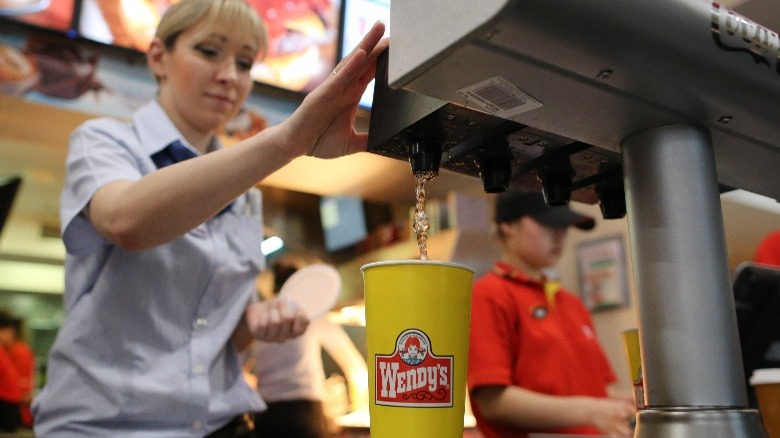 Wendy's employee pours soft drink