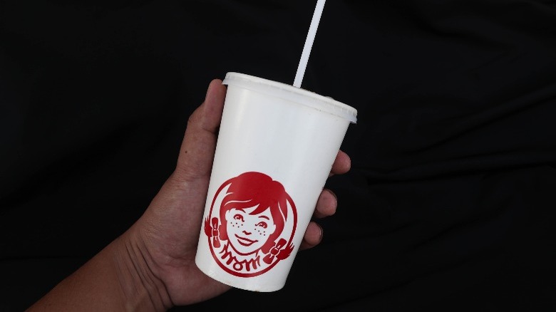 Hand holding Wendy's cup