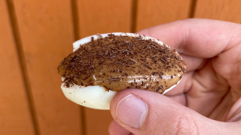 Hand holding chocolate deviled egg