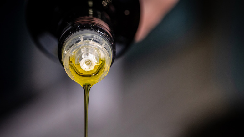 Olive oil poured from bottle