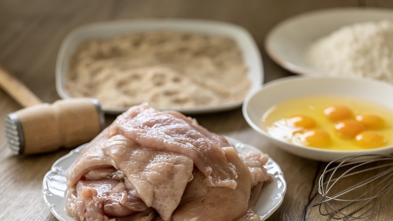 Raw chicken at breading station