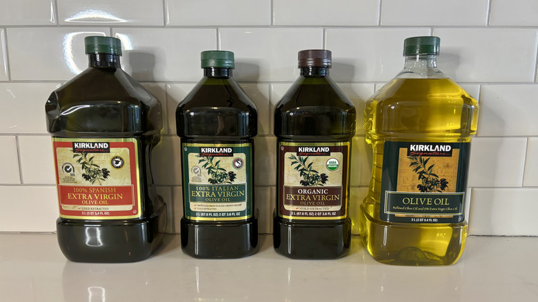 Four bottles of Kirkland Signature olive oil