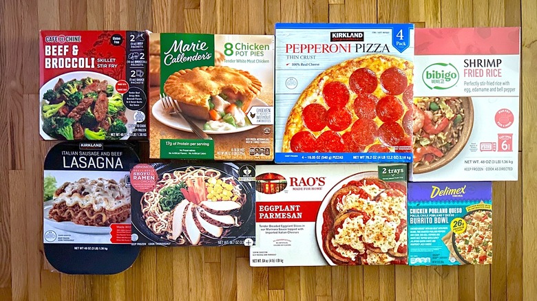 Assorted Costco frozen food boxes on wooden floor