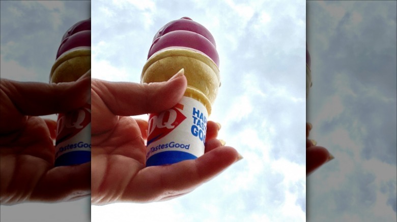 a hand holding the new Fruity Blast Dipped Cone from Dairy Queen