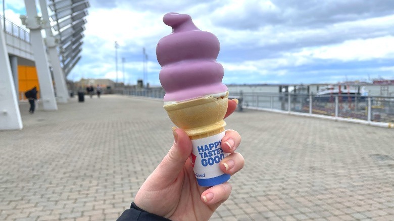 a hand holding the new Fruity Blast Dipped Cone from Dairy Queen