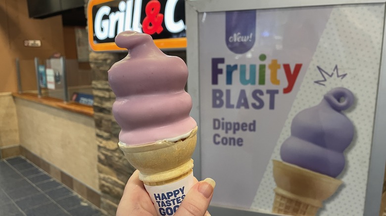 A fruity blast dipped cone in front of a dairy queen grill & chill location