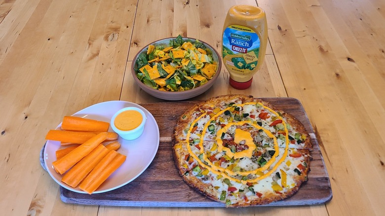 cheez it ranch dressing on a pizza, salad, and carrots