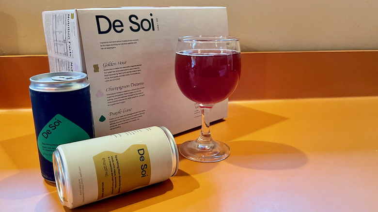 two de soi cans and wine glass with box