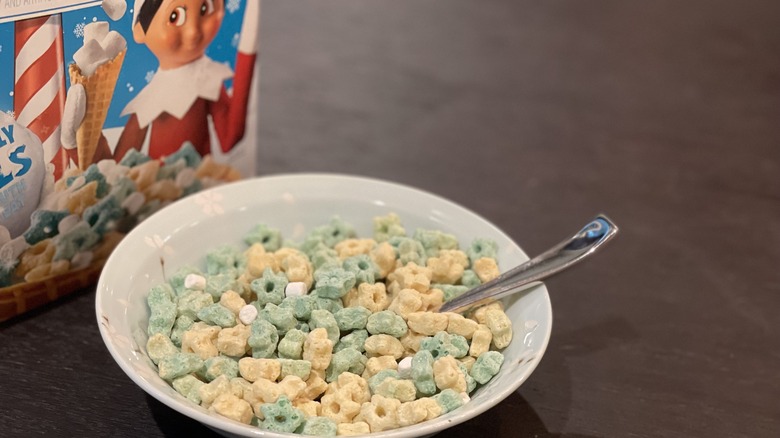 a bowl of cereal with a cereal box