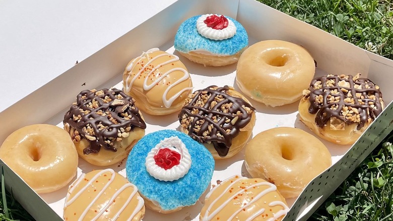 three krispy kreme doughnuts on box