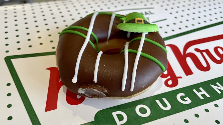 chocolate frosted doughnut with a sugar hat